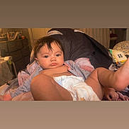 Whitley Jean is registered to the contest to win money with this photo: arm, baby, bed, bedding, blanket, cute, diaper, dresser, face, furniture, hair, indoors, infant, legs, lying_down, neutral_expression, nightstand, onesie, portrait, room