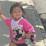 Juliette joined the competition — help win amazing prizes! bandana, child, concrete, hair_tie, happy, holding_hand, minnie_mouse, outdoor, person, pink_shirt, plush_toy, shadow, shorts, sidewalk, smile, sneakers, street, sunny_day, tree_shadow, walking
