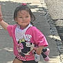 bandana, child, concrete, hair_tie, happy, holding_hand, minnie_mouse, outdoor, person, pink_shirt, plush_toy, shadow, shorts, sidewalk, smile, sneakers, street, sunny_day, tree_shadow, walking