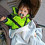 Maël participe au concours pour gagner de l'argent avec cette photo : toddler, child, stroller, blanket, pacifier, jacket, outdoor, baby, face, blue_eyes, clothing, seatbelt, comfort, person, infant, transport, casual, warm, cute, portrait