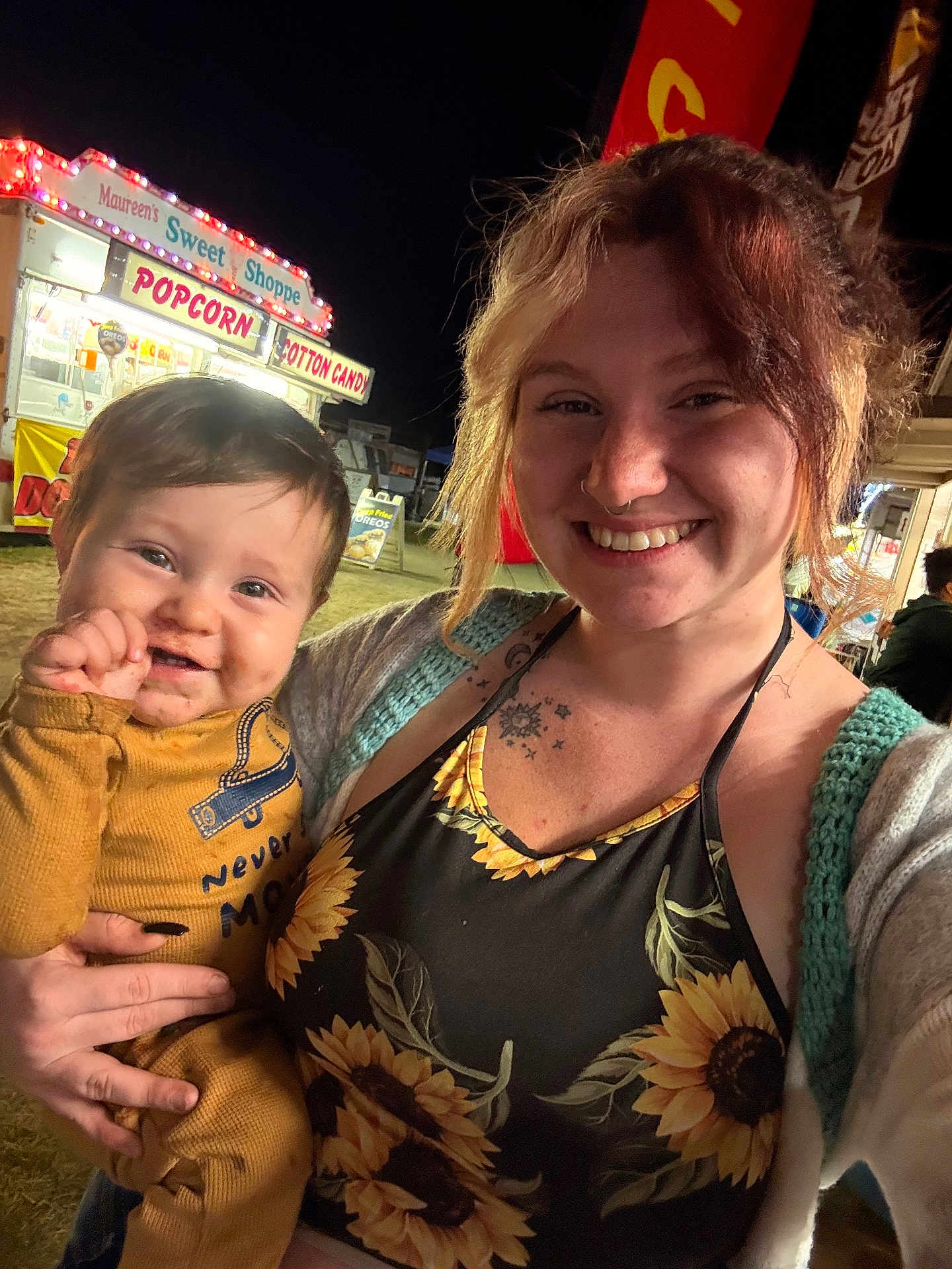 Phoenix joined the competition — help win amazing prizes! baby, child, woman, smiling, happy, portrait, night, outdoor, fairground, popcorn, cotton_candy, sign, clothing, tattoo, hand, face, person, festival, light, event