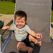 Phoenix joined the competition — help win amazing prizes! baby, child, smiling, outdoor, sunlight, chair, clothing, grass, trees, tshirt, shorts, happy, person, sitting, nature, daylight, cute, young, playful, relaxed