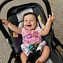 Phoenix joined the competition — help win amazing prizes! baby, stroller, smiling, happy, infant, child, pink_shirt, toy, seatbelt, barefoot, outdoor, person, cute, arms_up, sitting, playful, head, face, clothing, car_seat