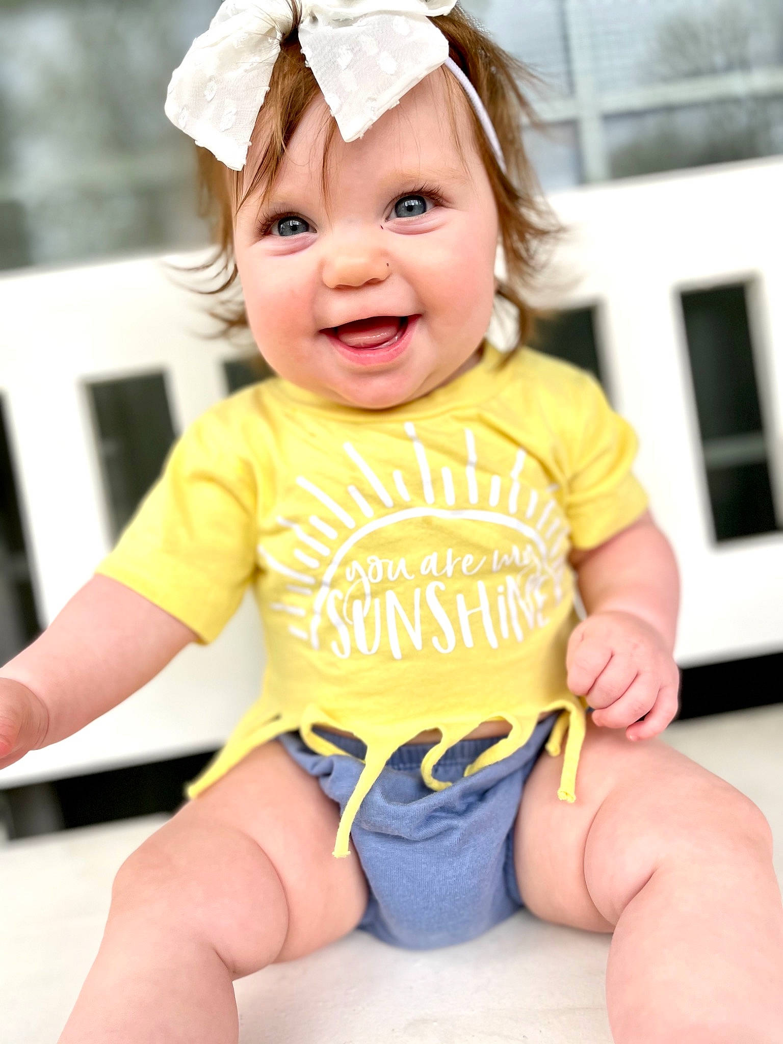 Georgia is registered to the contest to win money with this photo: baby_toddler_clothing, cheek, eye, face, facial_expression, finger, hand, happy, hat, head, headwear, human_body, leg, organ, person, photograph, pink, skin, sleeve, smile