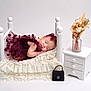 baby, sleeping, dress, headband, bed, lace, pillow, nightstand, vase, flowers, decor, purse, white, pink, furniture, cute, infant, portrait, indoor, rest