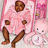 baby, blanket, bottle, box, child, cute, happy, headband, indoor, infant, newborn, octopus, pink, plush_toy, portrait, robe, smiling, soft_texture, three_months, toy