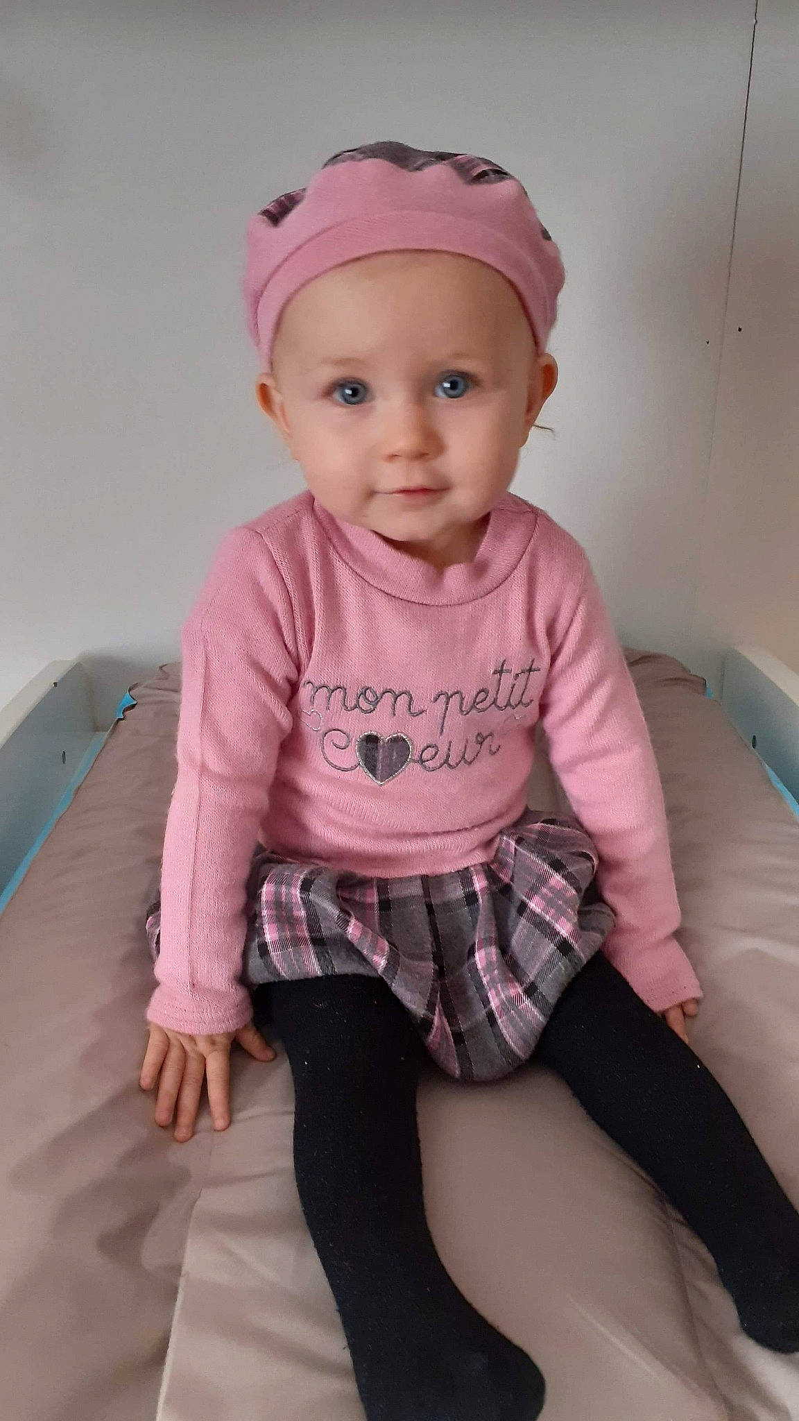 Talya participe au concours pour gagner de l'argent avec cette photo : baby, baby_toddler_clothing, cheek, chin, clothing, cool, eye, face, facial_expression, head, headwear, human_body, lip, organ, person, pink, product, shorts, skin, sleeve