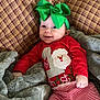 Lainey joined the competition — help win amazing prizes! baby, child, smiling, green_bow, red_shirt, striped_pants, plaid_couch, blanket, cozy, indoor, holiday, christmas, cute, infant, happy, portrait, relaxing, soft_texture, clothing, headband