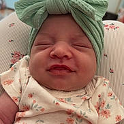 Phoebe joined the competition — help win amazing prizes! adorable, baby, bow, child, closeup, cushion, cute, face, floral_pattern, headband, home, indoor, infant, onesie, person, resting, sleepy, smiling, soft_lighting, young_child