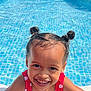 child, face, fun, girl, hair_buns, happy, outdoor, person, playful, polka_dot, portrait, red_swimsuit, skin, smiling, summer, sunlight, swimming_pool, water, water_droplets, young
