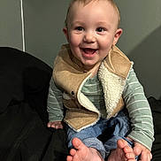 Liam joined the competition — help win amazing prizes! baby, child, smiling, happy, sitting, feet, toes, vest, clothing, jeans, long_sleeve, striped, indoor, person, cute, face, head, skin, fingers, cozy