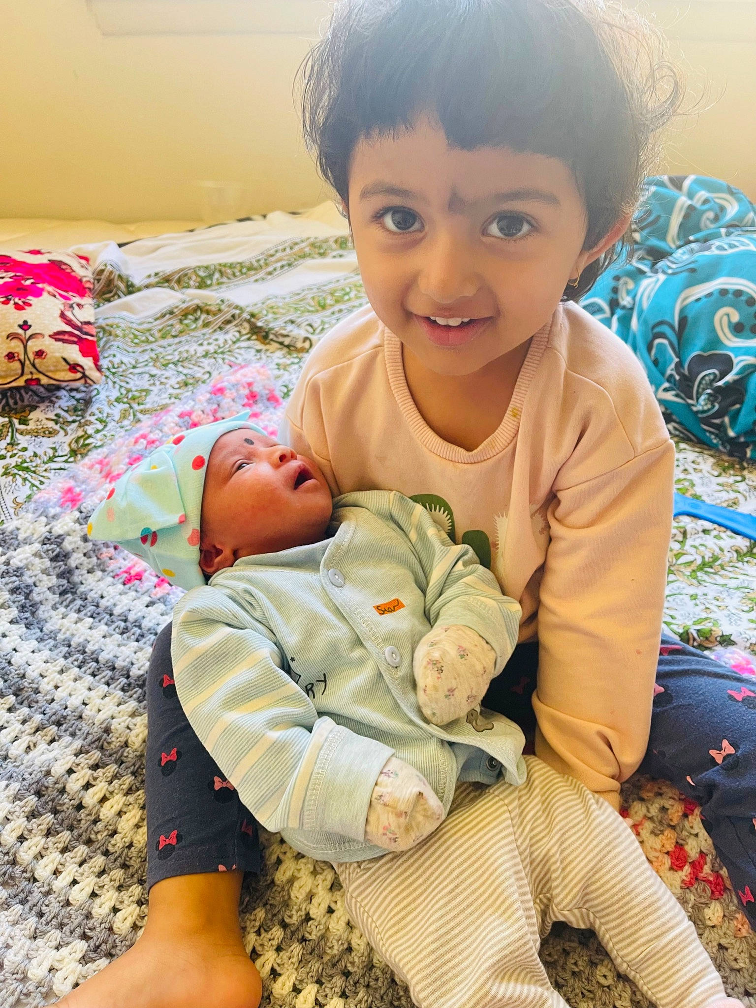 Sophia joined the competition — help win amazing prizes! baby, baby_toddler_clothing, cheek, child, comfort, eye, facial_expression, finger, fun, happy, human_body, joy, linens, pattern, person, sitting, skin, sleeve, smile, thigh