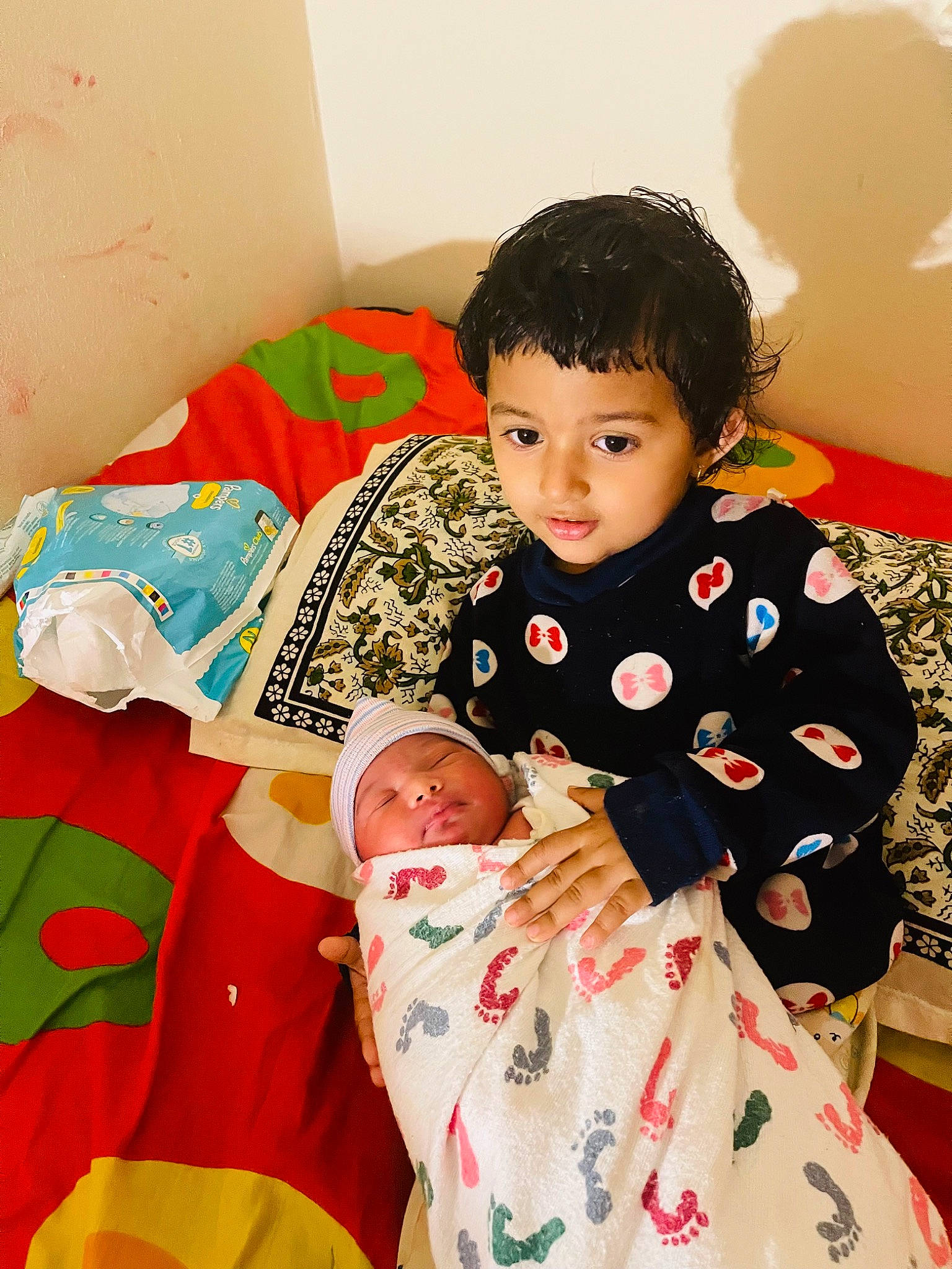 Sophia is registered to the contest to win money with this photo: baby, baby_toddler_clothing, bedding, child, comfort, couch, fun, happy, headwear, holiday, lap, linens, nightwear, pajamas, pattern, person, play, room, sitting, sleeve