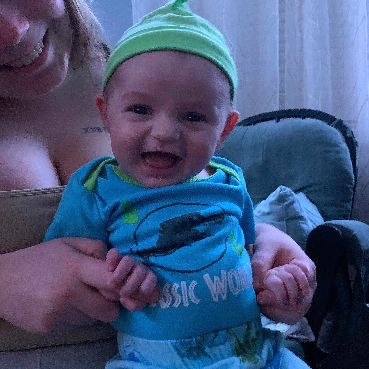 Lennon is registered to the contest to win money with this photo: baby, bodypart, bonnet, cap, clothing, couch, face, finger, furniture, hand, happy, hat, head, newborn, pants, person, photography, portrait, smile, t_shirt