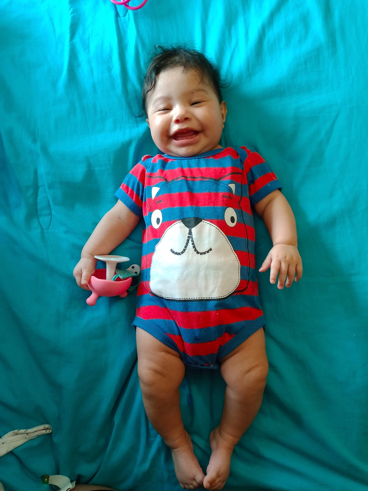 Alita is registered to the contest to win money with this photo: aqua, azure, baby, baby_toddler_clothing, comfort, eye, face, happy, head, knee, leg, person, pink, product, skin, sleeve, smile, stomach, textile, thigh