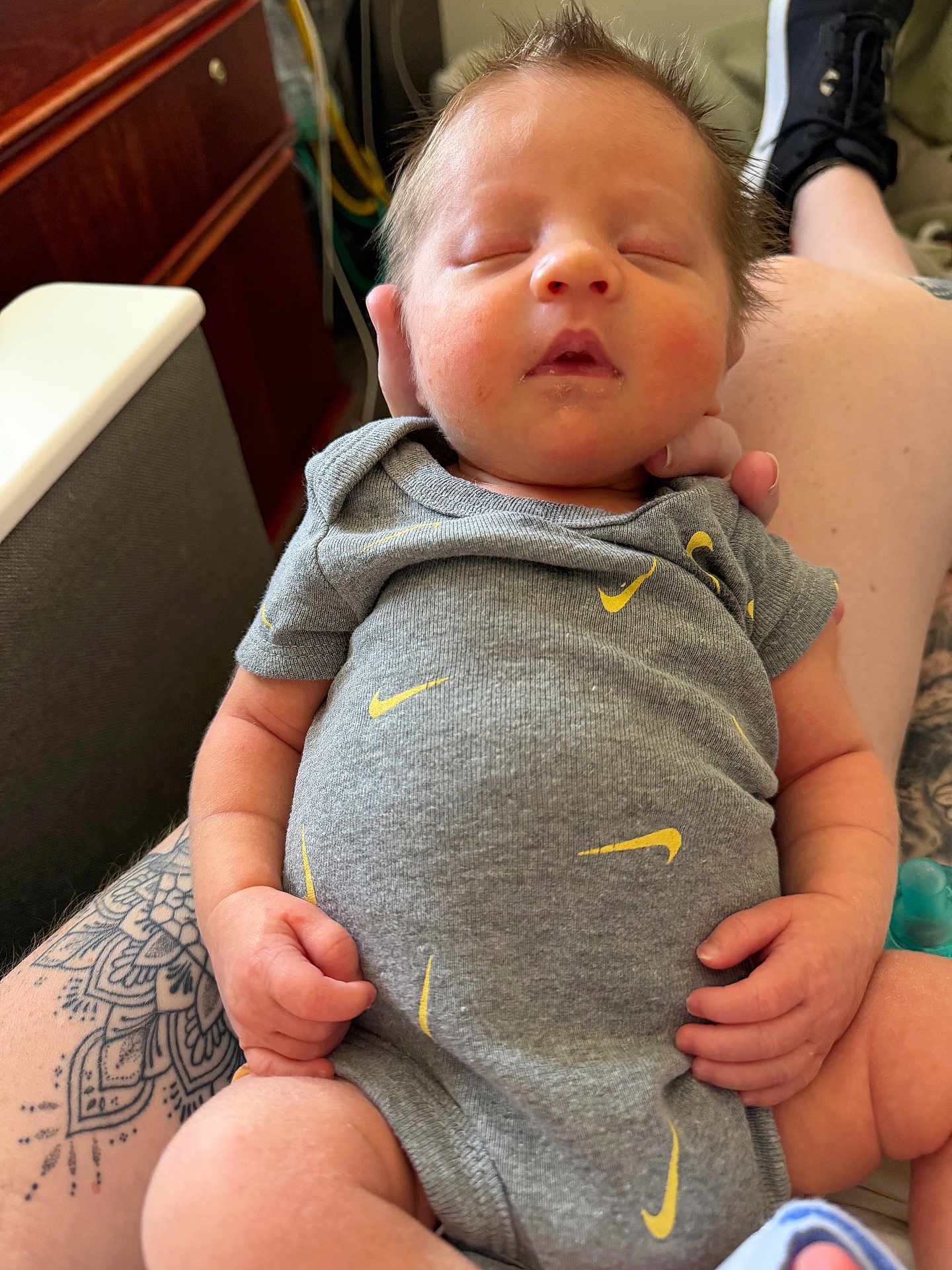 Grayson joined the competition — help win amazing prizes! baby, sleeping, onesie, tattoo, arm, hand, fingers, hair, indoor, furniture, couch, person, clothing, skin, legs, footwear, pacifier, relaxation, casual, closeup