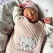 Mila participe au concours pour gagner de l'argent avec cette photo : newborn, baby, sleeping, pink, quilted, bear_patch, infant, cozy, baby_nest, soft, cute, peaceful, clothing, headwear, closeup, portrait, resting, child, indoor, swaddled