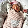 newborn, baby, sleeping, pink, quilted, bear_patch, infant, cozy, baby_nest, soft, cute, peaceful, clothing, headwear, closeup, portrait, resting, child, indoor, swaddled