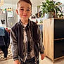 Liam a rejoint le concours — aidez-le/la à gagner de superbes lots ! boy, cabinet, casual, child, floor, furniture, home, indoor, jacket, kitchen, light, pants, person, plant, portrait, refrigerator, shirt, smile, window, young