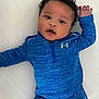 Kamari joined the competition — help win amazing prizes! baby, infant, blue_clothing, athletic_wear, under_armour, curly_hair, lying_down, white_background, cute, child, portrait, casual, one_arm_up, young_child, smiling, face, baby_boy, shorts, long_sleeve, playful