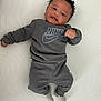 Kamari joined the competition — help win amazing prizes! baby, infant, smiling, clothing, sweatshirt, pants, socks, nike, curly_hair, lying_down, white_background, happy, cute, child, portrait, casual, indoor, person, one_person, young_child