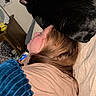 animal, bed, black_cat, blanket, casual, cat, comfort, cozy, furniture, hair, home, indoor, lamp, lying_down, nightstand, person, pet, relaxation, resting, sleeping