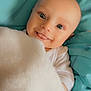 Ayrton participe au concours pour gagner de l'argent avec cette photo : baby, blanket, blue_bedding, child, cute, face, infant, lying_down, looking_at_camera, mouth_open, person, playful, portrait, smiling, tongue_out, white_clothing, young_child, cozy, soft_texture, happy