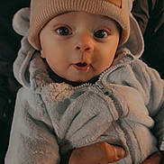 Ayrton a rejoint le concours — aidez-le/la à gagner de superbes lots ! baby, infant, hat, beanie, bear_ears, fuzzy_clothing, hand, ring, closeup, portrait, cute, warm_lighting, eyes, face, child, winter_clothing, person, holding, expression, soft_texture