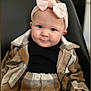 Lyana participe au concours pour gagner de l'argent avec cette photo : baby, child, infant, headband, bow, plaid, coat, black_top, blue_eyes, smile, face, sitting, chair, indoors, cute, young_child, fashion, portrait, warm_clothing, person