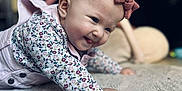 Lyana participe au concours pour gagner de l'argent avec cette photo : baby, infant, crawling, headband, bow, floral_shirt, tongue_out, carpet, indoor, cute, smiling, child, playful, young, person, home, soft, happy, face, apparel