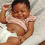 Ariyah is registered to the contest to win money with this photo: baby, infant, smiling, curly_hair, diaper, pink_clothing, cushioned_seat, relaxed, closed_eyes, happy, skin, hand, leg, indoor, child, cute, sleepy, toddler, comfort, portrait
