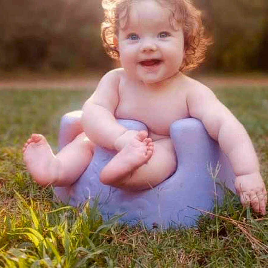 Allison is registered to the contest to win money with this photo: baby, ball, bathroom, face, football, grass, happy, head, indoors, outdoors, person, photography, plant, portrait, room, sitting, soccer, soccerball, sport, toilet
