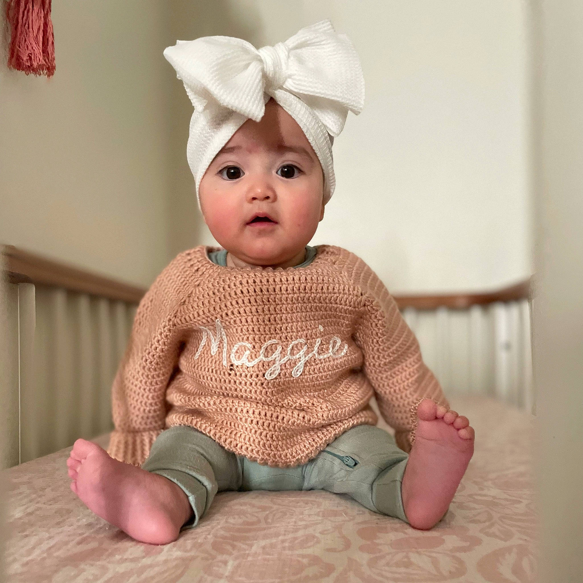Margaret joined the competition — help win amazing prizes! baby, baby_toddler_clothing, cap, cheek, child, costume_hat, fashion_accessory, flooring, fur, happy, headwear, pattern, peach, person, pink, sitting, skin, sleeve, surprise, toddler