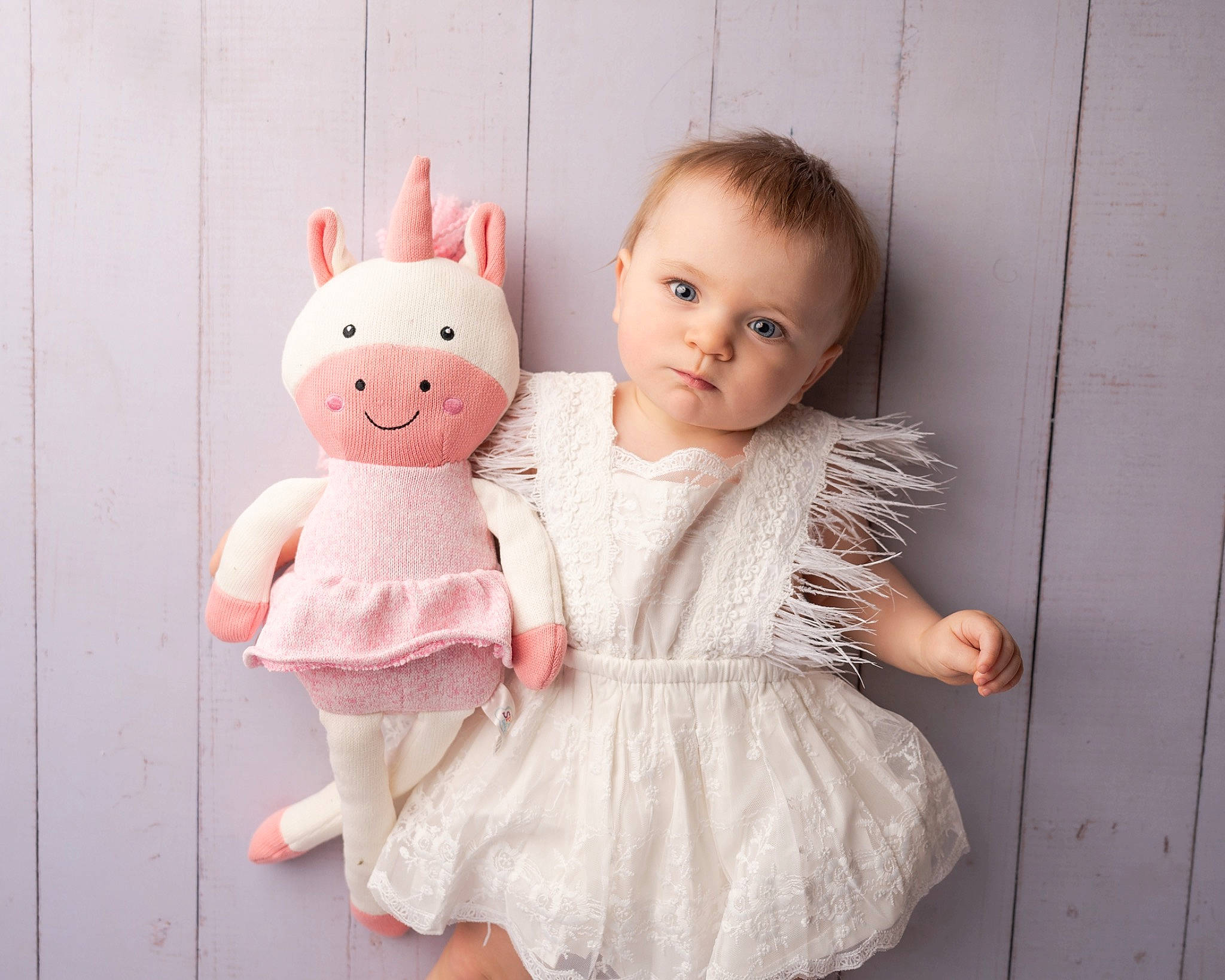 Temperance is registered to the contest to win money with this photo: arm, baby, baby_toddler_clothing, cheek, child, dress, face, fur, gesture, hand, happy, head, human_body, person, pink, skin, sleeve, textile, toddler, toy