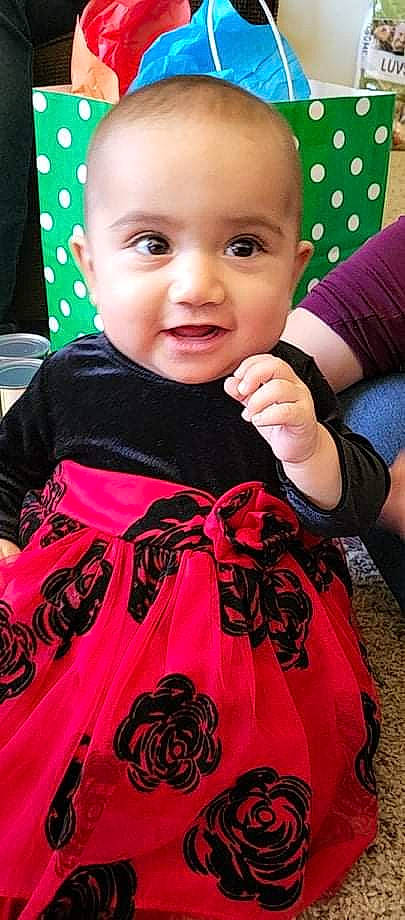 Erika joined the competition — help win amazing prizes! baby, baby_toddler_clothing, beauty, cheek, eyelash, face, gesture, happy, head, lip, magenta, pattern, person, pink, skin, sleeve, smile, t_shirt, textile, thumb