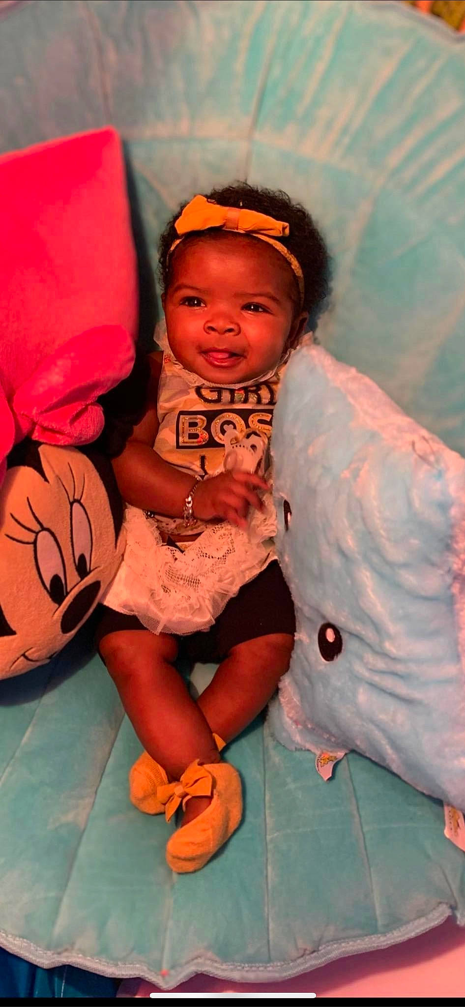 Katria is registered to the contest to win money with this photo: baby, child, cool, event, eye, fun, happy, hat, human_leg, leisure, mouth, orange, person, pink, sandal, sitting, smile, stuffed_toy, t_shirt, thigh