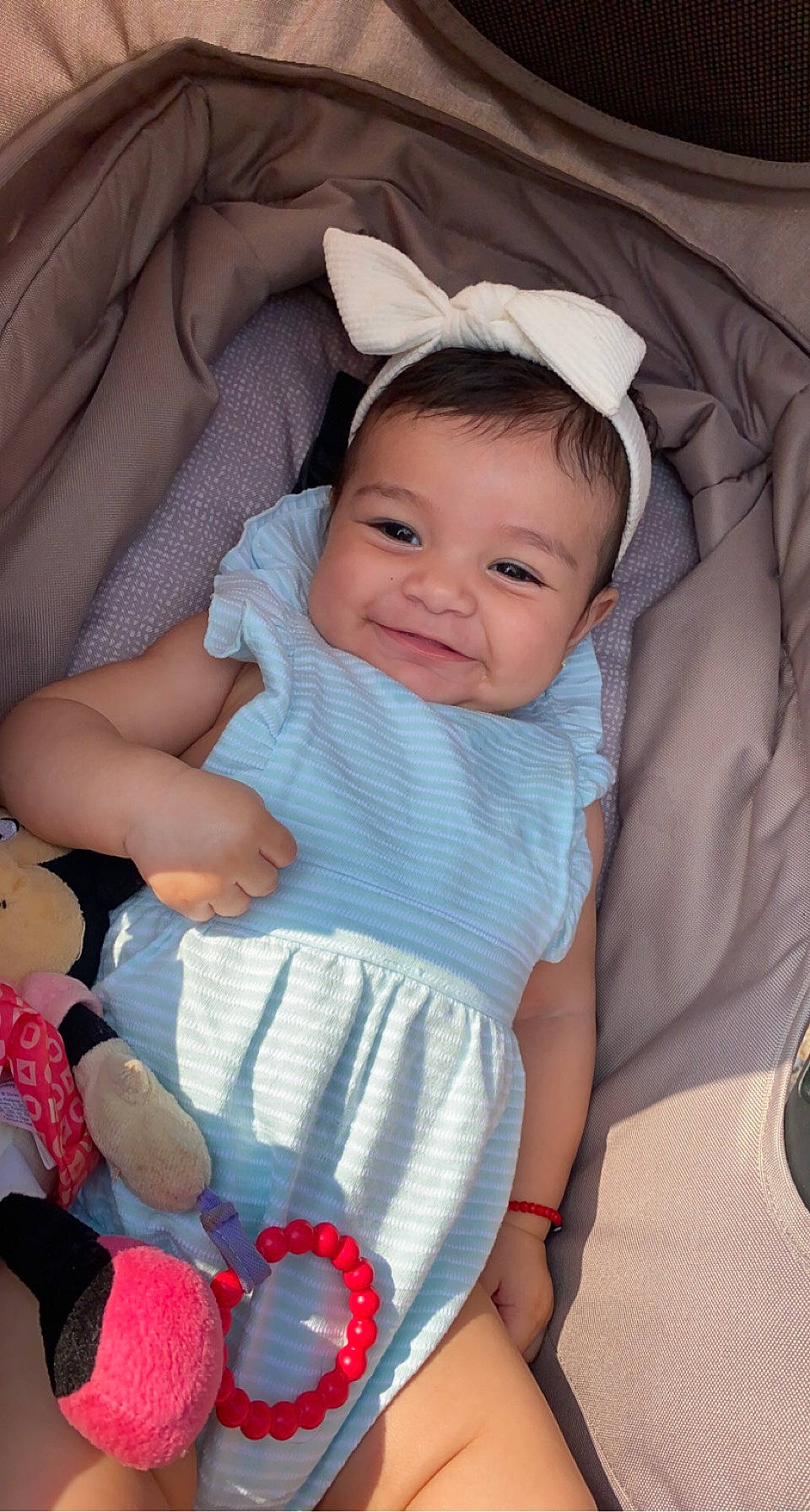 Myla is registered to the contest to win money with this photo: baby, baby_carriage, baby_products, baby_toddler_clothing, cheek, child, comfort, eye, happy, head, human_body, iris, joy, lap, person, pink, skin, sleeve, smile, textile