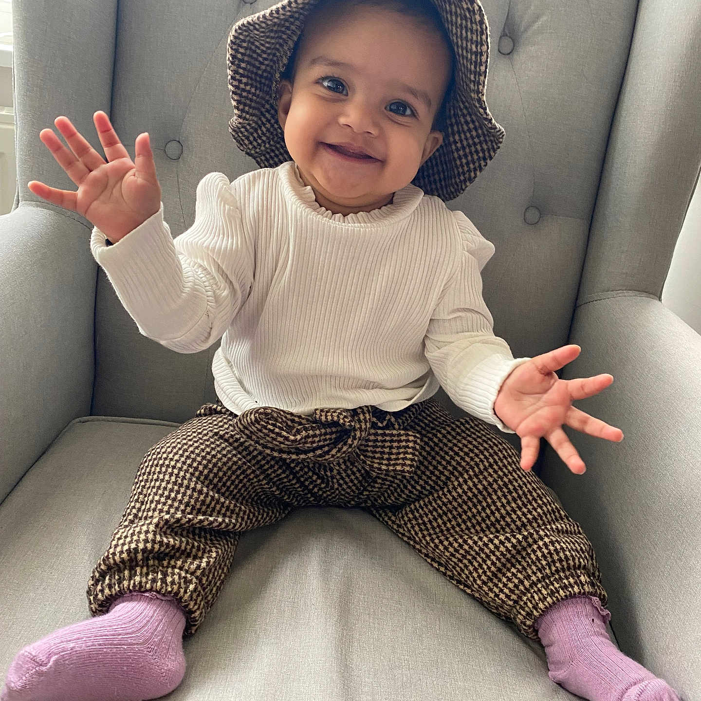 Lalita is registered to the contest to win money with this photo: baby, babylaughing, bodypart, chair, clothing, face, finger, furniture, hand, happy, hat, head, hosiery, pants, person, photography, portrait, sitting, smile, sock