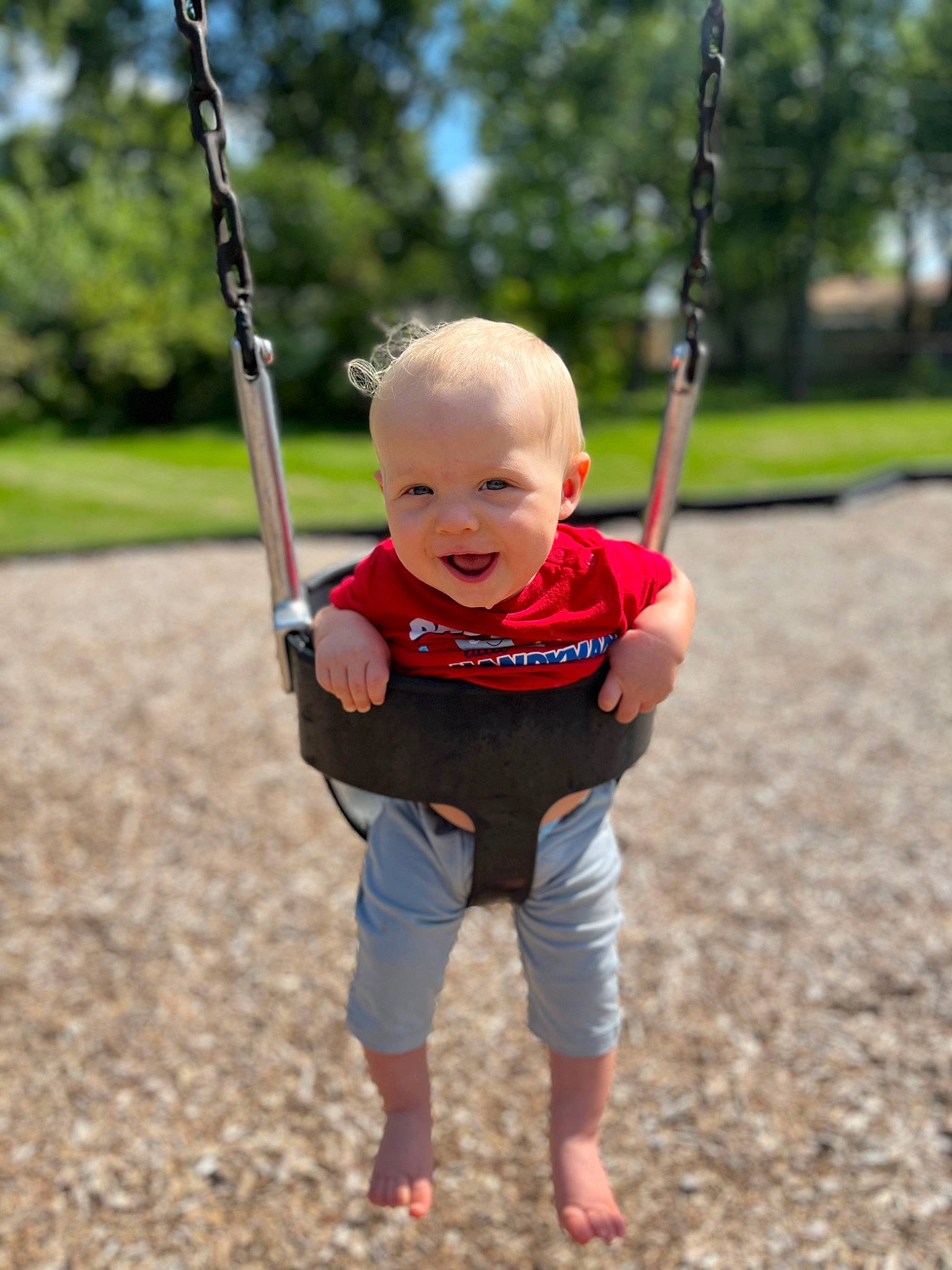 River joined the competition — help win amazing prizes! arm, baby, black, eye, face, finger, grass, happy, head, human_body, leisure, people_in_nature, person, plant, playground, sleeve, standing, swing, toddler, tree
