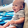 Jaidyn joined the competition — help win amazing prizes! baby, smiling, infant, striped_clothing, sitting, couch, blanket, happy, indoor, child, cute, cheerful, portrait, young_child, skin, face, hand, legs, comfort, room