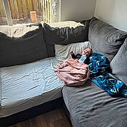 Jaidyn joined the competition — help win amazing prizes! baby, blanket, bottle, couch, corner_couch, floor, glass_door, happy, indoors, living_room, person, pillow, plush, smiling, wood_floor, window, daylight, relaxing, child, casual