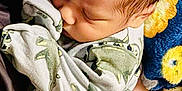 Jaidyn is registered to the contest to win money with this photo: arm, baby, blanket, blue_blanket, child, close_up, cozy, cute, dinosaur_onesie, hand, indoor, infant, newborn, person_holding, rest, sleep, sleeping, soft_texture, warmth, yellow_pattern
