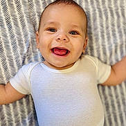 Jaidyn joined the competition — help win amazing prizes! baby, blanket, cheerful, child, cute, expression, face, happy, head, indoors, infant, lying_down, onesie, pattern, person, portrait, skin, smiling, toddler, young