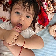 Yanis participe au concours pour gagner de l'argent avec cette photo : baby, infant, child, blanket, foot, hand, bracelet, skin, face, mouth, hair, white_clothing, curious, laying_down, indoors, cute, expression, closeup, person, soft_texture