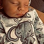 Gabriel a rejoint le concours — aidez-le/la à gagner de superbes lots ! baby, sleeping, infant, clothing, hat, elephant, animal_print, closeup, peaceful, cute, child, soft_light, hand, newborn, portrait, indoors, fabric, toddler, sleep, cozy