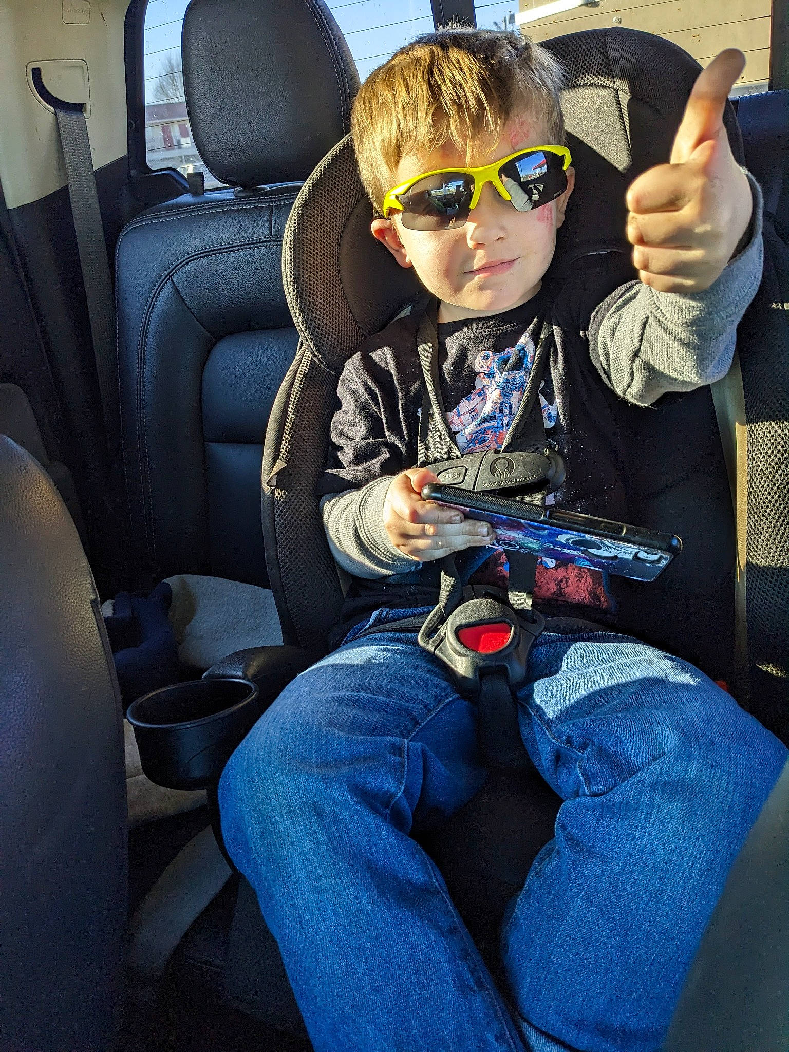 Tommy is registered to the contest to win money with this photo: auto_part, automotive_design, automotive_exterior, car_seat, car_seat_cover, denim, electric_blue, eyewear, glasses, goggles, head_restraint, jeans, motor_vehicle, person, personal_protective_equipment, recreation, sunglasses, toddler, vehicle, vehicle_door