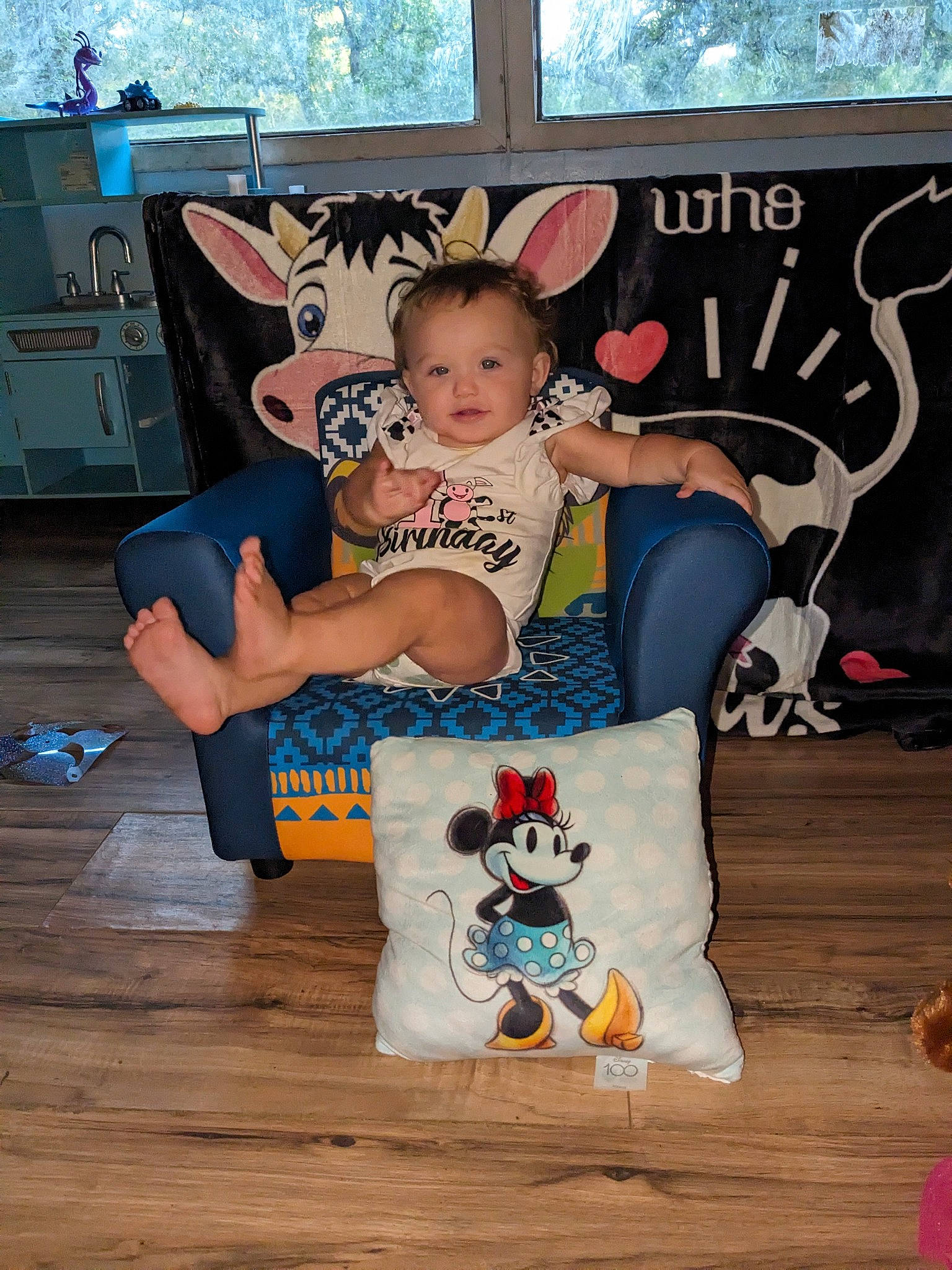 Amelia is registered to the contest to win money with this photo: baby, baby_toddler_clothing, child, costume, event, fawn, flooring, font, fun, happy, hardwood, leisure, person, room, sitting, smile, t_shirt, toddler, wood, world