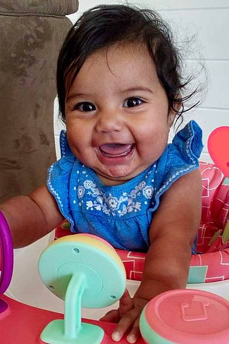 Marcella is registered to the contest to win money with this photo: baby_playing_with_toys, baby_toddler_clothing, beauty, cheek, child, chin, electric_blue, facial_expression, fun, happy, joy, leisure, person, pink, plastic, product, red, sitting, skin, smile