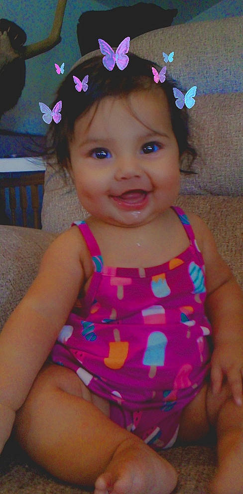 Marcella is registered to the contest to win money with this photo: baby_toddler_clothing, blue, cheek, clothing, facial_expression, fun, happy, iris, joy, lip, neck, person, photograph, pink, purple, skin, sleeve, smile, summer, textile