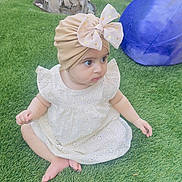 Iman Ali Khan joined the competition — help win amazing prizes! baby, child, grass, outdoor, dress, headwear, turban, bow, playground, toy, purple_ball, yellow_car, curious, sitting, barefoot, greenery, cute, infant, person, daylight